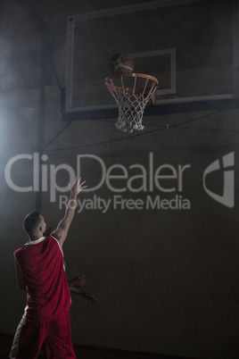 Portrait of basketball player scoring a goal