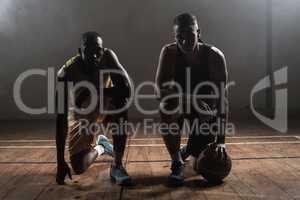 Portrait basketball players posing on their knees
