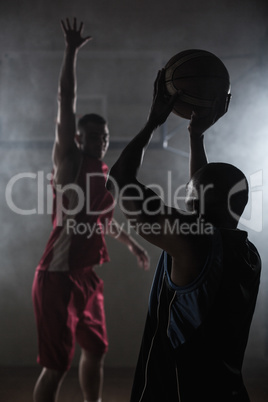 Portrait of two men playing basketball