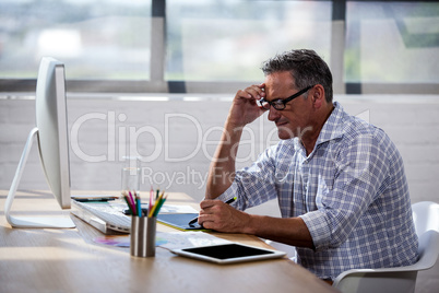 Side view of a businessman working at desk