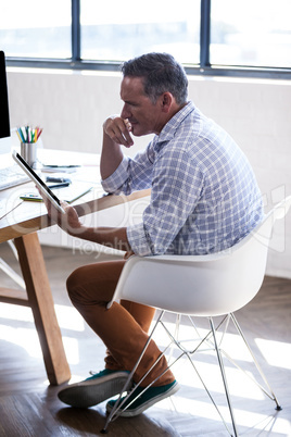 Profile view of a man using a digital tablet