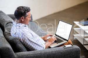 Profile view of a businessman working on computer