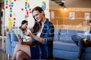 Woman using digital tablet with colleagues