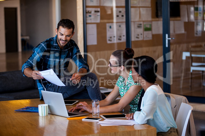 Colleagues working at computer desk