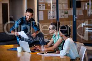 Colleagues working at computer desk