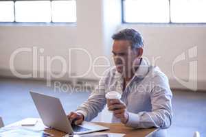 Businessman working at desk with laptop