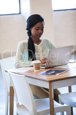 A serious woman working on laptop
