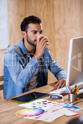 An attractive man working at computer desk