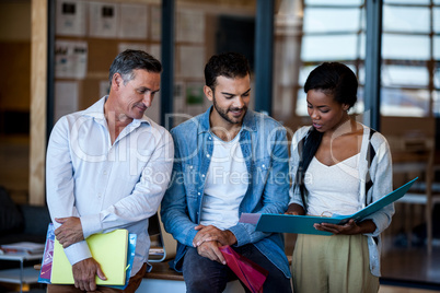 Team of coworkers discussing