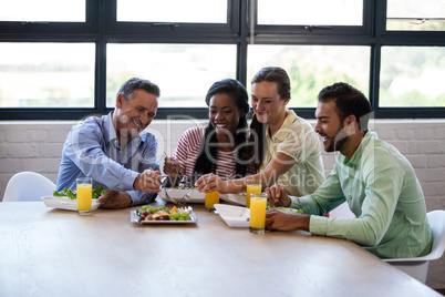 Smiling team of  business people having lunch