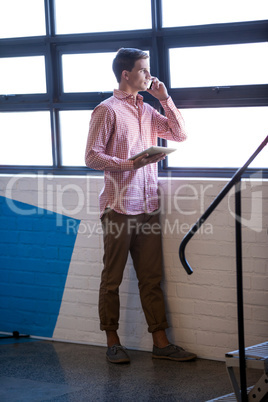 Portrait of young businessman having a phone call