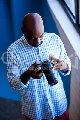 Close up view of businessman looking at camera while standing