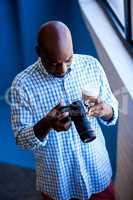 Close up view of businessman looking at camera while standing