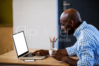 Profile view of a businessman working on computer