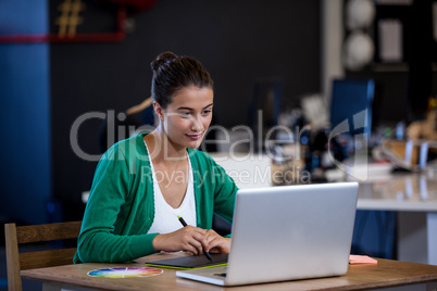 Close up view of attractive woman working at desk