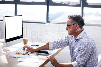 Profile view of a businessman working on computer