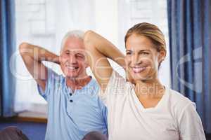 Fitness instructor and senior doing exercises