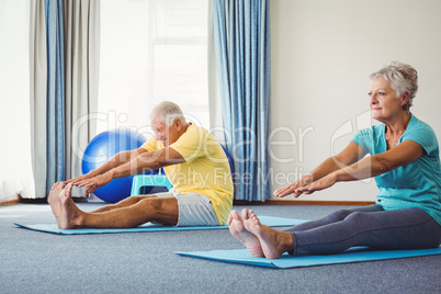 Side view of seniors doing exercises