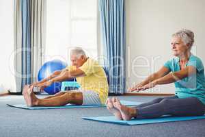 Side view of seniors doing exercises