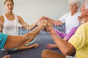 Concentrated seniors holding hands together in circle