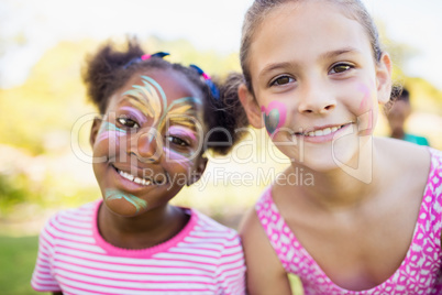 Portrait of cute girls with make up smiling and looking the came