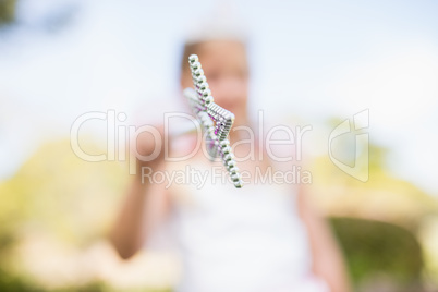 Blurred picture of girl pretending to be a fairy and pointing th