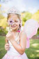 Portrait of cute girl with fairy dress looking across her magic
