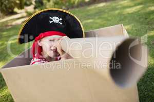 Portrait of a boy with pirate dress playing with cardboard spygl