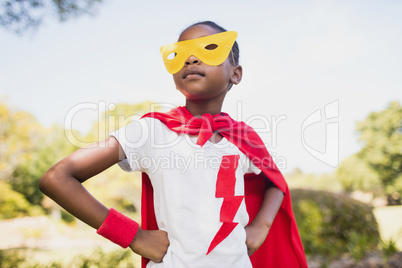 Portrait of cute girl pretending to be a superhero