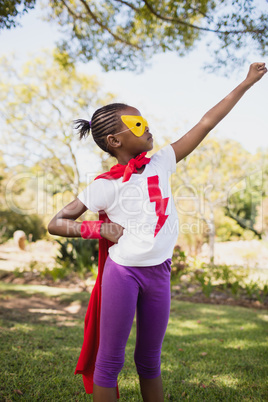 Portrait of cute girl pretending to be a superhero