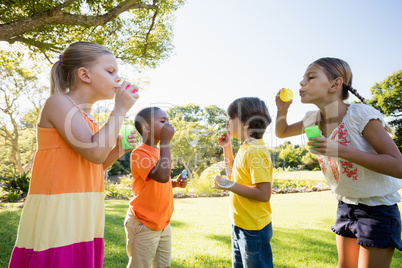 Cute children playing with bubbles