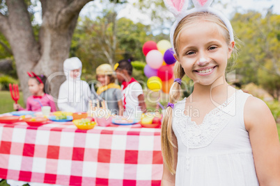 Portrait of cute girl smiling and posing in front of a birthday