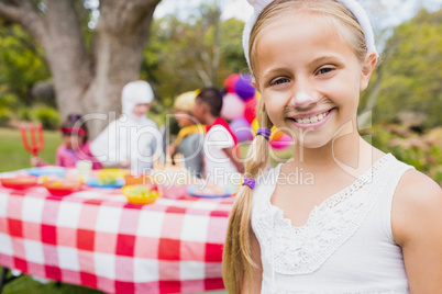 Cute girl smiling and posing in front of a birthday party