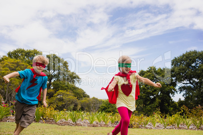 Children with superhero dress running and smiling