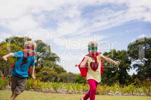 Children with superhero dress running and smiling