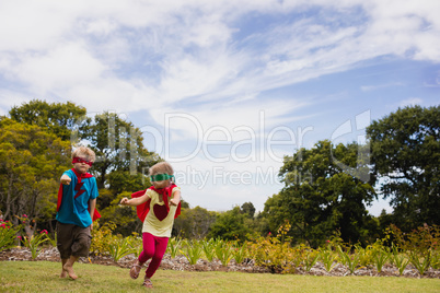 Children with superhero dress running and smiling