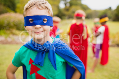 Portrait of young boy smiling and wearing a superhero dress