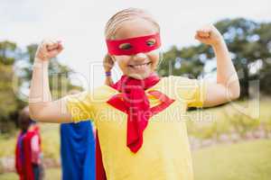 Portrait of young girl with superhero dress smiling and showing