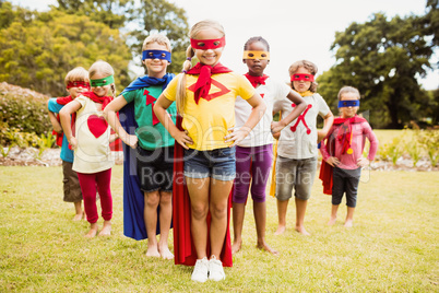 Group of children with superhero dress posing with hands on hips