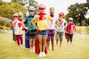 Group of children with superhero dress posing with hands on hips