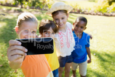 Happy children holding each other and taking a selfie