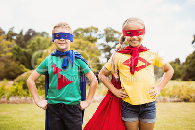 Children smiling and posing with superhero dress