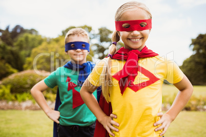 Children smiling and posing with superhero dress