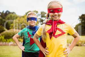 Children smiling and posing with superhero dress