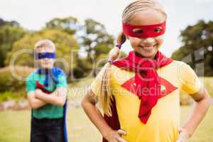 Portrait of young girl with superhero dress posing in front of a
