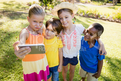 Cute children holding each other and taking a selfie
