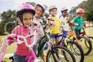 Portrait of children wearing helmet and posing on their bikes