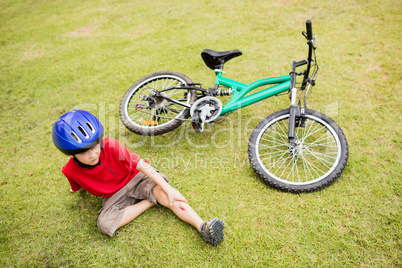 Young boy falling of his bike