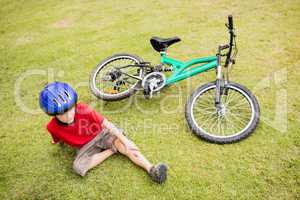 Young boy falling of his bike