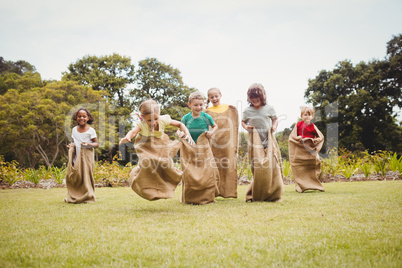 Children enjoying and doing a bag race